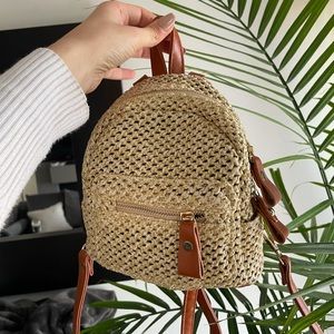 A mini back pack. Faux leather straps. Golden detail.